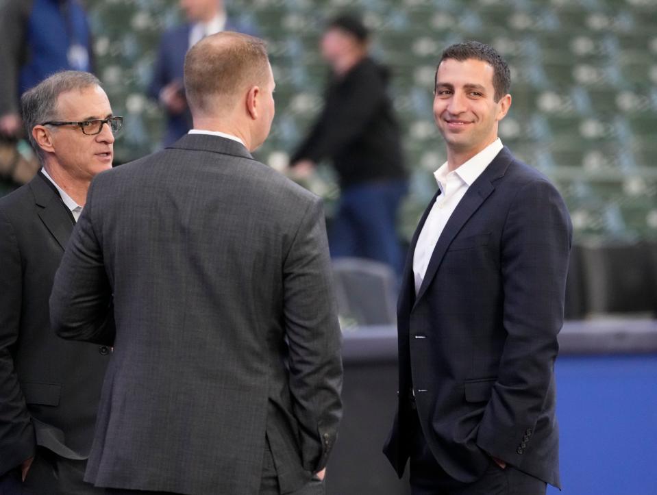 David Stearns, right, Milwaukee Brewers president of baseball operations, and Rick Schlesinger, far left, president, business operations are seen before the Milwaukee Brewers home opener against St. Louis Cardinals at American Family Field in Milwaukee on Thursday, April 14, 2022.