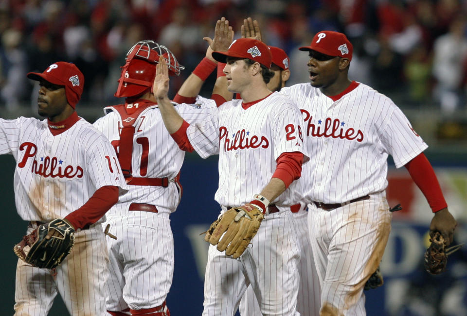 Philadelphia Phillies (L-R) Jimmy Rollins, Carlos Ruiz, Chase Utley and Ryan Howard celebrate after defeating the Tampa Bay Rays in Game 4 of Major League Baseball's World Series in Philadelphia, October 26, 2008. REUTERS/Tim Shaffer (UNITED STATES)