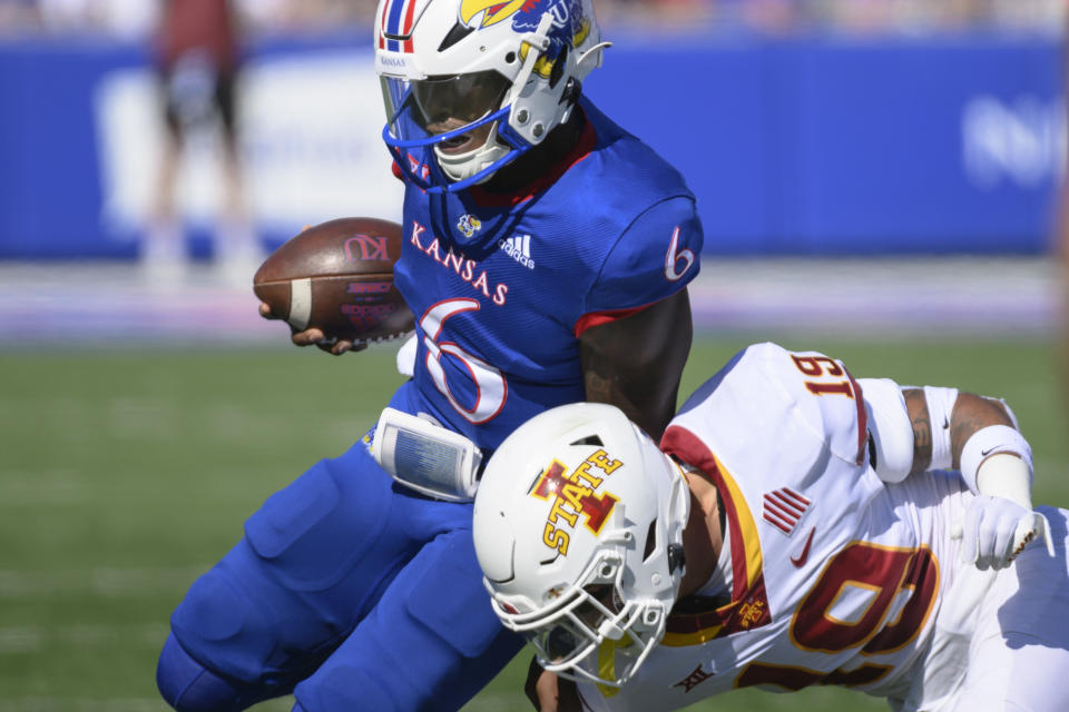 Kansas quarterback Jalon Daniels (6) is tackled by Iowa State defensive back Jeremiah Cooper (19) during the first half of an NCAA college football game, Saturday, Oct. 1, 2022, in Lawrence, Kan. (AP Reed/Hoffmann)