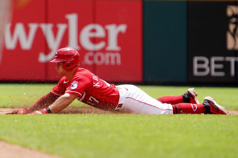 Reds catcher Mark Kolozsvary slides in safely at second base after hitting a double during a game on July 28.