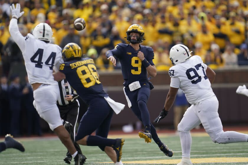 Michigan quarterback J.J. McCarthy (9) throws against Penn State in the first half.