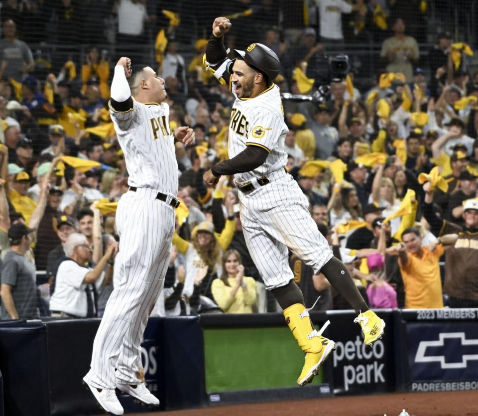 The Padres' Trent Grisham, right, celebrates his solo homer with Manny Machado during the fourth inning Oct. 14, 2022.