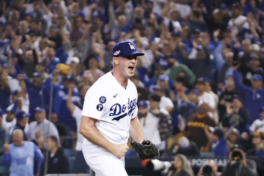 Dodgers relief pitcher Evan Phillips (59) reacts after San Diego Padres Wil Myers hits a ground ball into a double play