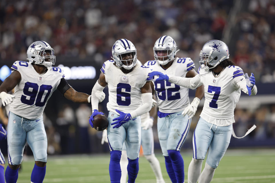 Dallas Cowboys defensive back Donovan Wilson (6) celebrates with teammates Trevon Diggs (7) DeMarcus Lawrence (90) Dorance Armstrong (92) after an interception against the Tampa Bay Buccaneers on September 11, 2022, in Arlington, Texas. (AP Photo/Matt Patterson)