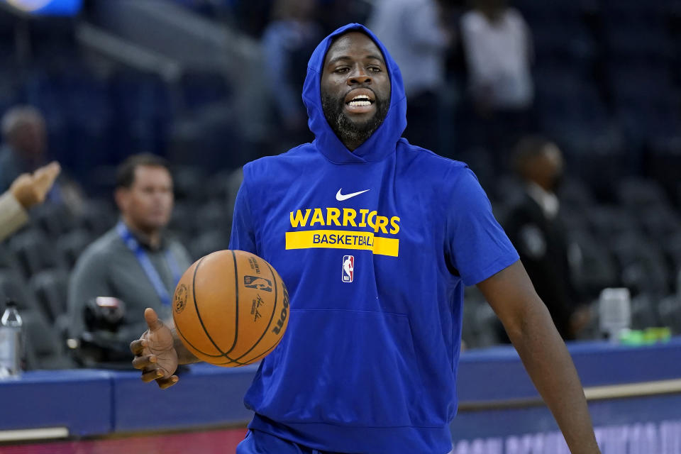 Golden State Warriors forward Draymond Green warms up before an NBA preseason basketball game against the Denver Nuggets in San Francisco, Friday, Oct. 14, 2022. (AP Photo/Jeff Chiu)