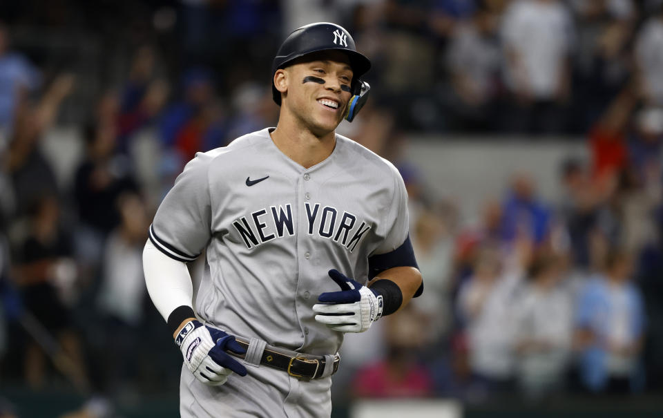 ARLINGTON, TX - OCTOBER 4: Aaron Judge #99 of the New York Yankees rounds the bases after hitting his 62nd home run of the season against the Texas Rangers during the first inning in game two of a double header at Globe Life Field on October 4, 2022 in Arlington, Texas. Judge has now set the American League record for home runs in a single season. (Photo by Ron Jenkins/Getty Images)