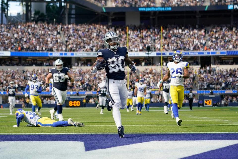 Dallas Cowboys running back Tony Pollard (20) reaches the end zone after a long run for a touchdeown as Los Angeles Rams safety Terrell Burgess (26) and others pursue in the first half of an NFL football game, Sunday, Oct. 9, 2022, in Inglewood, Calif. (AP Photo/Ashley Landis)