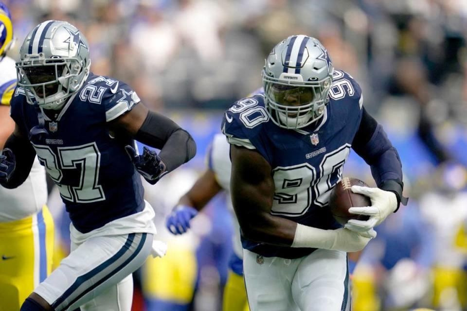 Dallas Cowboys safety Jayron Kearse (27) helps defend as defensive end DeMarcus Lawrence (90) returns a Los Angeles Rams’ Matthew Stafford fumble for a touchdown in the first half of an NFL football game, Sunday, Oct. 9, 2022, in Inglewood, Calif.