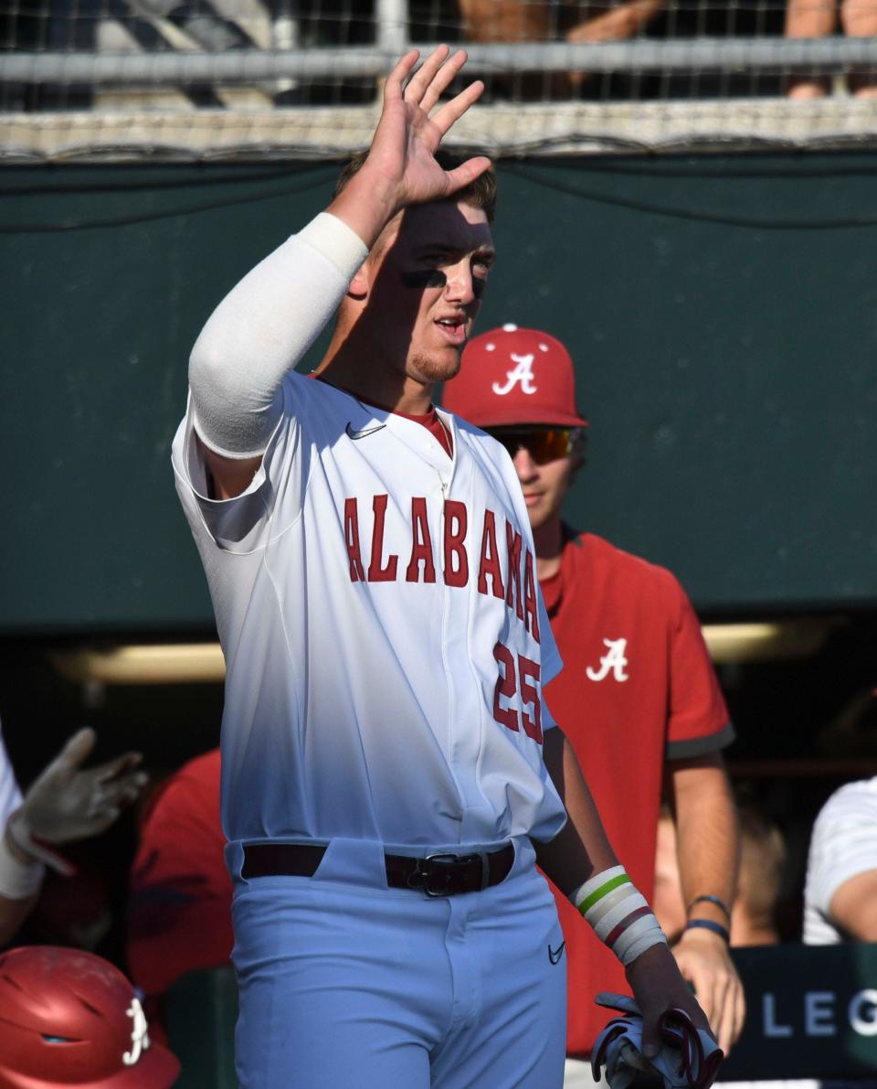 Alabama infielder Davis Heller (25) waits to congratulate Alabama outfielder Andrew Pinckney (21) after he scored a run against Murray State at Sewell-Thomas Stadium Friday, March 4, 2022. 