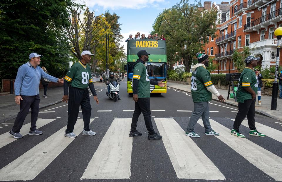 Green Bay Packers president Mark Murphy, left, along with former players Marv Fleming, James Jones, Nick Collins and LeRoy Butler transit the Abbey Road crosswalk made famous by the Beatles during a tour Friday.