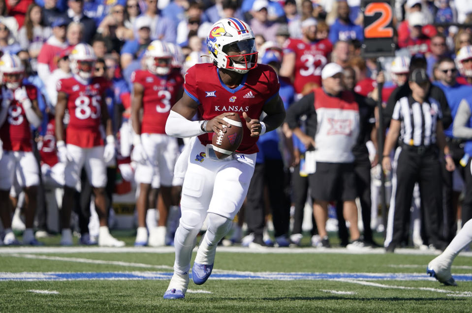 LAWRENCE, KANSAS - OCTOBER 08: Quarterback Jalon Daniels #6 of the Kansas Jayhawks rolls out as he looks to pass in the first half against the TCU Horned Frogs at David Booth Kansas Memorial Stadium on October 08, 2022 in Lawrence, Kansas. (Photo by Ed Zurga/Getty Images)