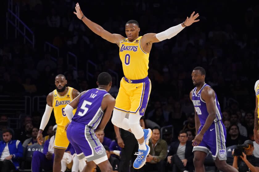 Los Angeles Lakers guard Russell Westbrook, second from right, jumps as he guards Sacramento Kings guard De'Aaron Fox