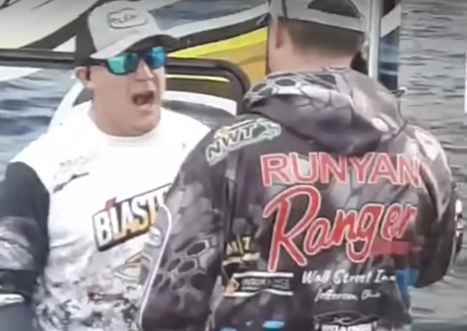 Jason Fischer yells at Jake Runyan after Fischer found weights inside Runyan's fish at the final event of the Lake Erie Walleye Trail. (@billyhottakes/Twitter)