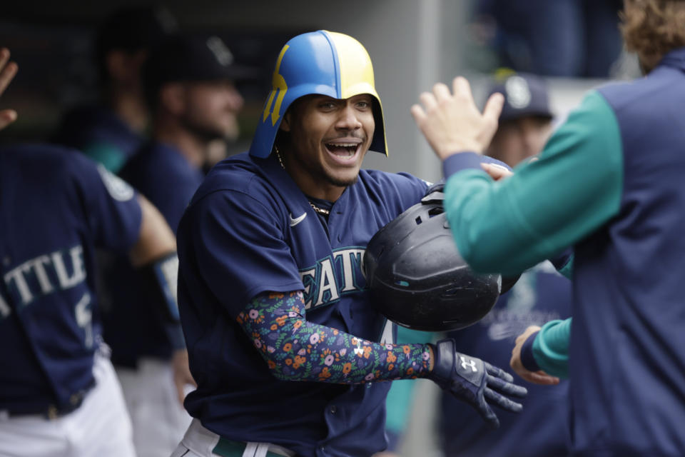 Seattle Mariners' Julio Rodriguez celebrates in the dugout after hitting a home run against the Detroit Tigers on Wednesday, Oct. 5, 2022, in Seattle. (AP Photo/John Froschauer)