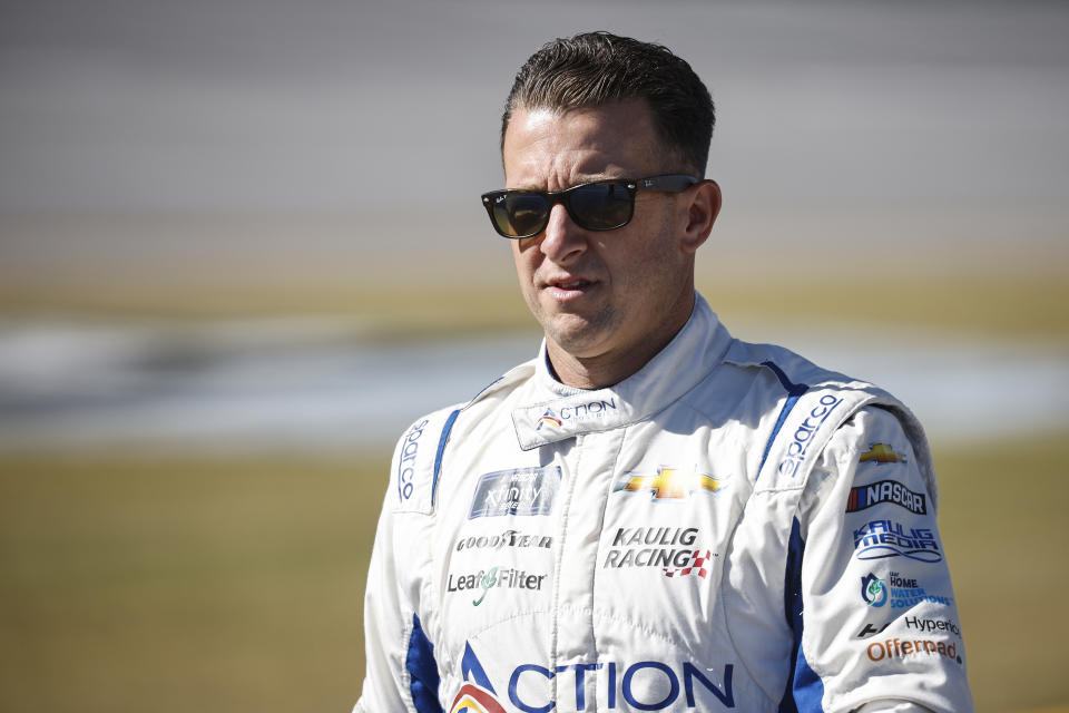  AJ Allmendinger, driver of the No. 16 Action Industries Chevrolet, walks the grid prior to the NASCAR Xfinity Series Sparks 300 at Talladega Superspeedway on October 01, 2022 in Talladega, Alabama. (Photo by Sean Gardner/Getty Images)