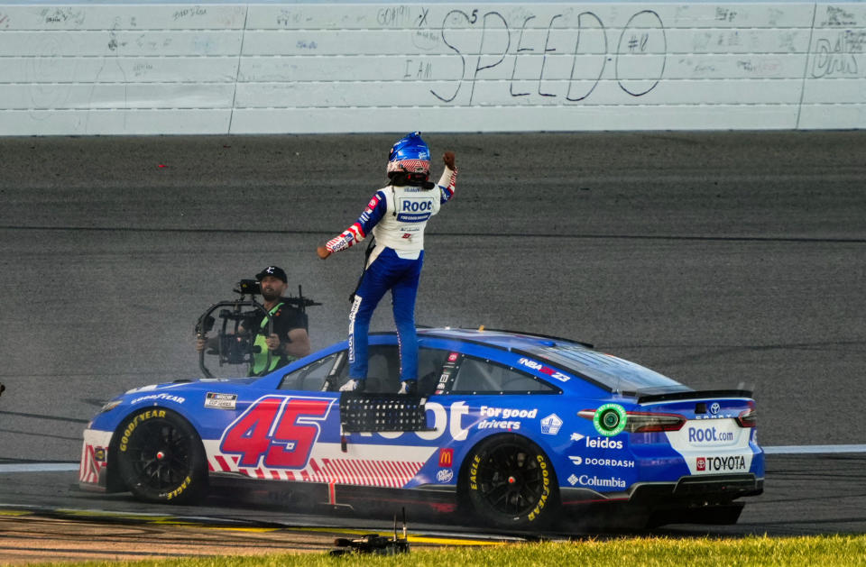 Sep 11, 2022; Kansas City, Kansas, USA; NASCAR Cup Series driver Bubba Wallace (45) celebrates after winning the Hollywood Casino 400 at Kansas Speedway. Mandatory Credit: Jay Biggerstaff-USA TODAY Sports