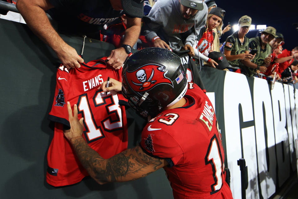 TAMPA, FLORIDA - NOVEMBER 22: Mike Evans #13 of the Tampa Bay Buccaneers signs an autograph after a win against the New York Giants at Raymond James Stadium on November 22, 2021 in Tampa, Florida. (Photo by Mike Ehrmann/Getty Images)