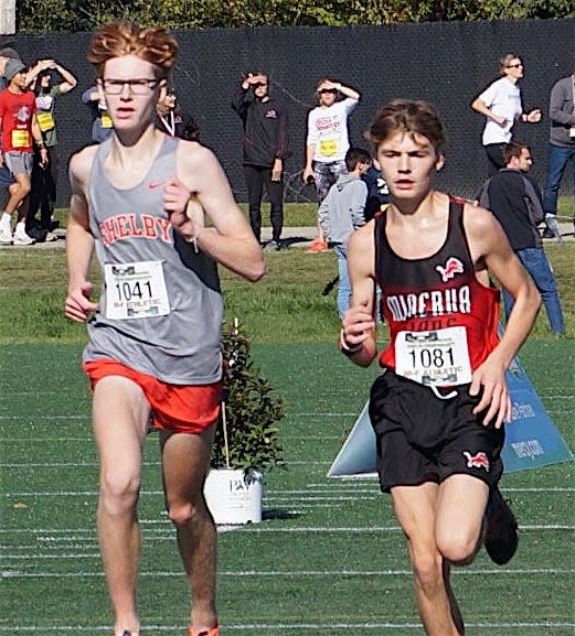 Minerva's Owen Grubb (right) competes in the Division II boys race at last year's state cross country meet.