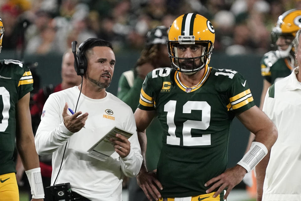 Green Bay Packers head coach Matt LaFleur, left, is running an offense that quarterback Aaron Rodgers doesn't appear to agree love right now. (AP Photo/Morry Gash)