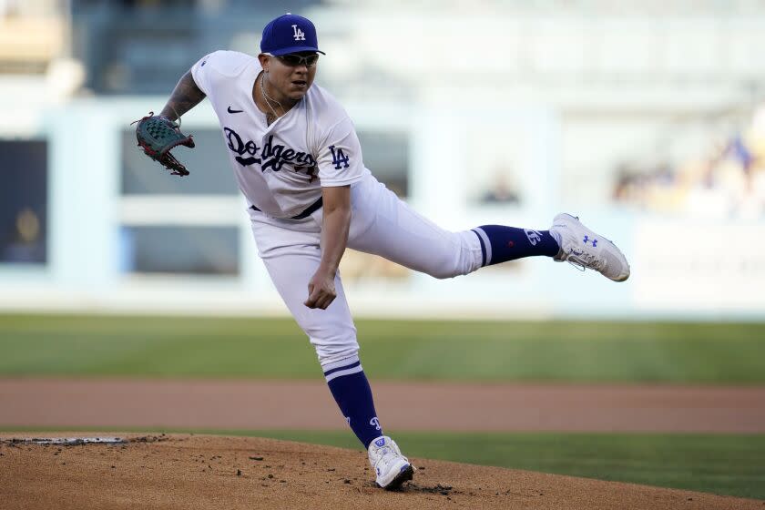 Los Angeles Dodgers starting pitcher Julio Urias throws to a San Diego Padres batter.