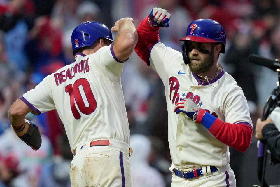 Philadelphia Phillies' Bryce Harper celebrates after a two-run home run with J.T. Realmuto during the eighth inning in Game 5 of the baseball NL Championship Series between the San Diego Padres and the Philadelphia Phillies on Sunday, Oct. 23, 2022, in Philadelphia. (AP Photo/Matt Slocum)