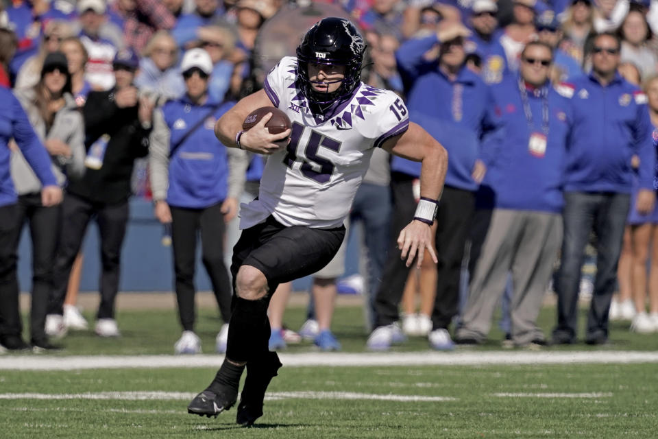 TCU quarterback Max Duggan (15) runs the ball against Kansas Saturday, Oct. 8, 2022, in Lawrence, Kan. TCU won the game 38-31. (AP Photo/Charlie Riedel)