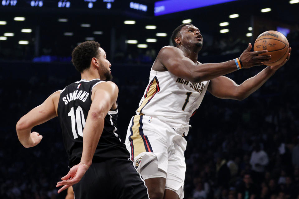 NEW YORK, NEW YORK - OCTOBER 19: Zion Williamson #1 of the New Orleans Pelicans goes to the basket as Ben Simmons #10 of the Brooklyn Nets defends during the first half at Barclays Center on October 19, 2022 in the Brooklyn borough of New York City. NOTE TO USER: User expressly acknowledges and agrees that, by downloading and or using this photograph, User is consenting to the terms and conditions of the Getty Images License Agreement. (Photo by Sarah Stier/Getty Images)