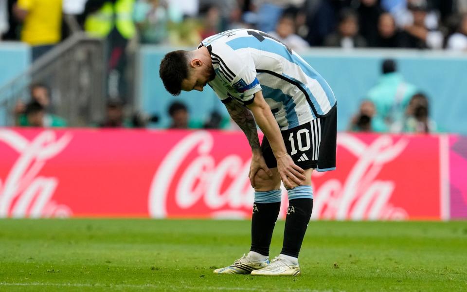 Argentina's Lionel Messi stands on the pitch disappointed during the World Cup group C soccer match - AP