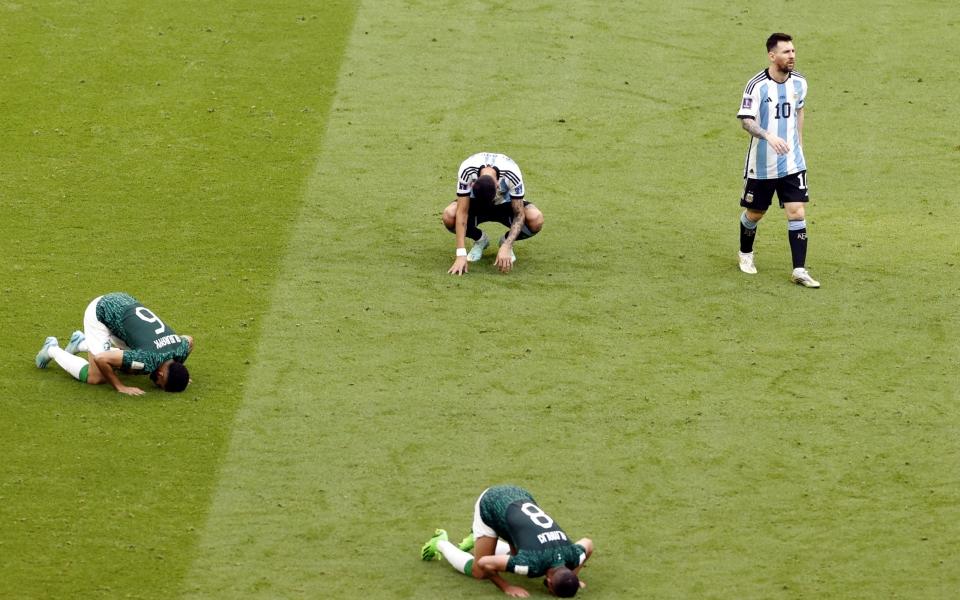  Lionel Messi of Argentina (R) and other players react after the FIFA World Cup 2022 group C soccer match between Argentina and Saudi Arabia - SHUTTERSTOCK