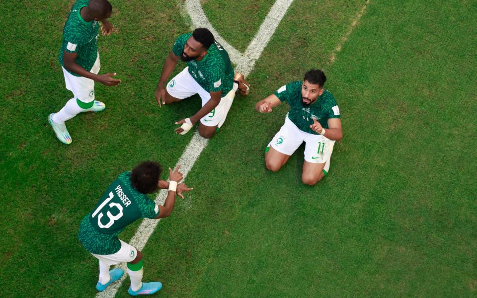 Saudi Arabia's Saleh Al-Shehri celebrates scoring their first goal with teammates - REUTERS/Peter Cziborra