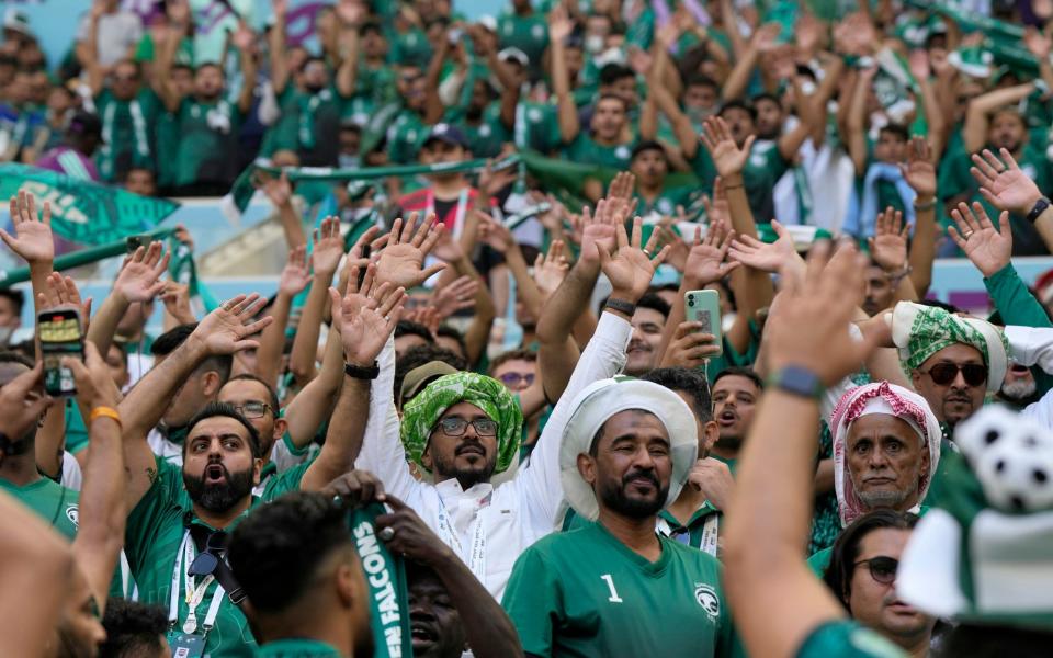 Saudi Arabia soccer fans sing prior to the the World Cup group C soccer match between Argentina and Saudi Arabia - AP/Ricardo Mazalan