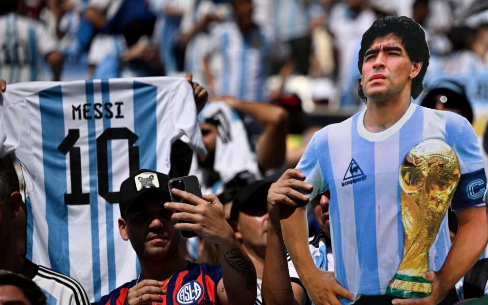 Argentina's suporters wave a jersey of Argentina's forward #10 Lionel Messi and an effigy depictying football legend Diego Maradona - AFP/ KIRILL KUDRYAVTSEV