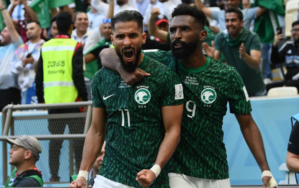 Saudi Arabia's Saleh Al-Shehri celebrates scoring their first goal with Feras Al Brikan - REUTERS/Annegret Hilse