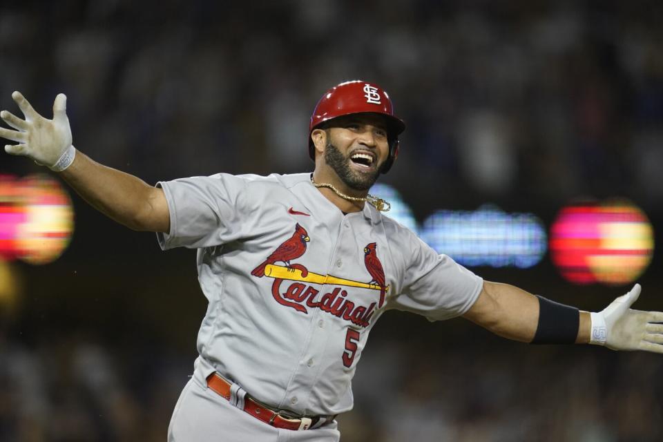 St. Louis Cardinals designated hitter Albert Pujols celebrates after hitting his 700th career home run.