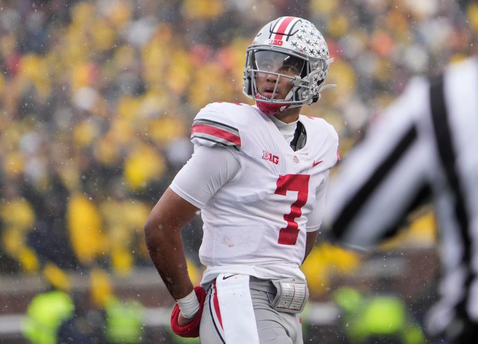 Ohio State Buckeyes quarterback C.J. Stroud (7) walks off the field during the second quarter of the NCAA football game at Michigan Stadium in Ann Arbor on Saturday, Nov. 27, 2021.