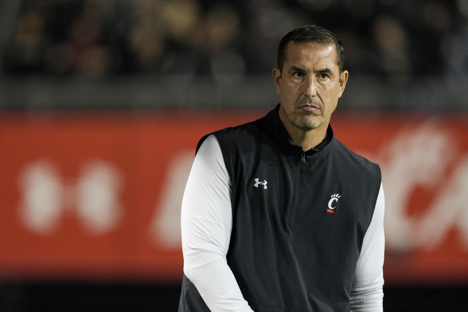 Cincinnati head coach Luke Fickell walks onto the field prior to the first half of an NCAA college football game against East Carolina, Friday, Nov. 11, 2022, in Cincinnati. (AP Photo/Jeff Dean)