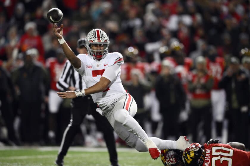 Ohio State quarterback C.J. Stroud throws the ball under pressure against Maryland