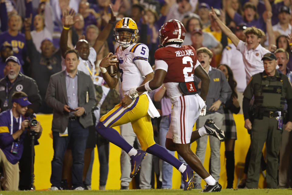 LSU quarterback Jayden Daniels (5) runs the ball past Alabama defensive back DeMarcco Hellams (2) during the game at Baton Rouge, La., Saturday, Nov. 5, 2022. (AP Photo/Tyler Kaufman)