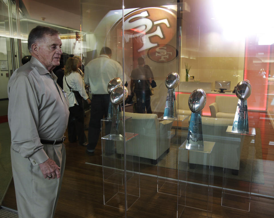 Retired San Francisco 49ers general manager John McVay looks at five 49ers Super Bowl trophies from his time with the NFL football team, at the Preview Center in Santa Clara, Calif., where a model of a proposed new stadium for the 49ers was on display Tuesday, Sept. 27, 2011. (AP Photo/Paul Sakuma)