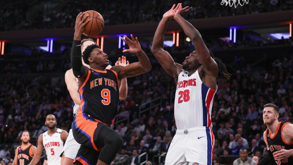 RJ Barrett drives to basket against two Pistons city connect black jerseys