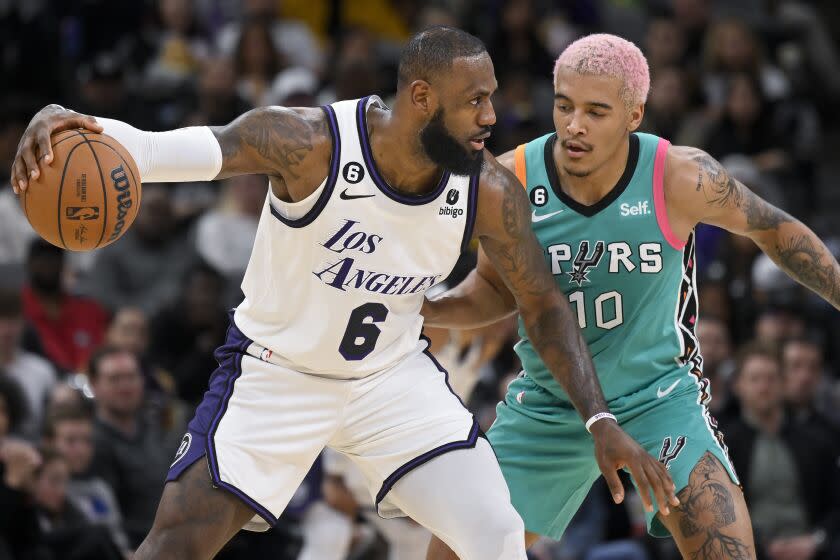 Los Angeles Lakers' LeBron James (6) drives is defended by San Antonio Spurs' Jeremy Sochan during the first half of an NBA basketball game Friday, Nov. 25, 2022, in San Antonio. (AP Photo/Darren Abate)