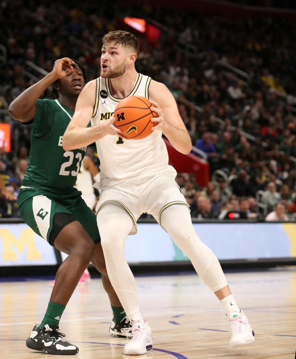 Michigan center Hunter Dickinson drives against Eastern Michigan forward Legend Geeter during the second half of U-M's 88-83 win on Friday, Nov. 9, 2022, at Little Caesars Arena.