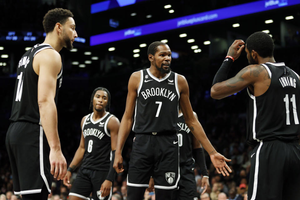 NEW YORK, NEW YORK - OCTOBER 27: Kevin Durant #7 talks with Ben Simmons #10 and Kyrie Irving #11 of the Brooklyn Nets during the second half against the Dallas Mavericks at Barclays Center on October 27, 2022 in the Brooklyn borough of New York City. The Mavericks won 129-125. NOTE TO USER: User expressly acknowledges and agrees that, by downloading and or using this photograph, User is consenting to the terms and conditions of the Getty Images License Agreement. (Photo by Sarah Stier/Getty Images)