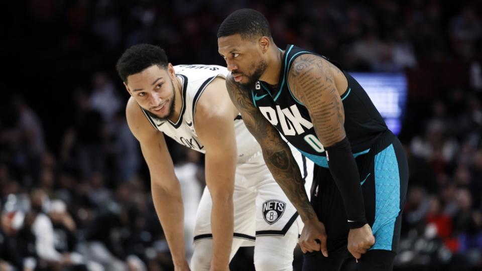 Ben Simmons smiling next to Damian Lillard white jersey