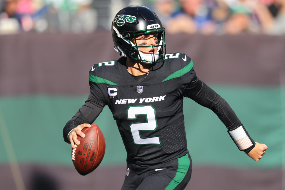 Zach Wilson #2 of the New York Jets runs with the ball during the second half of an NFL game against the New England Patriots