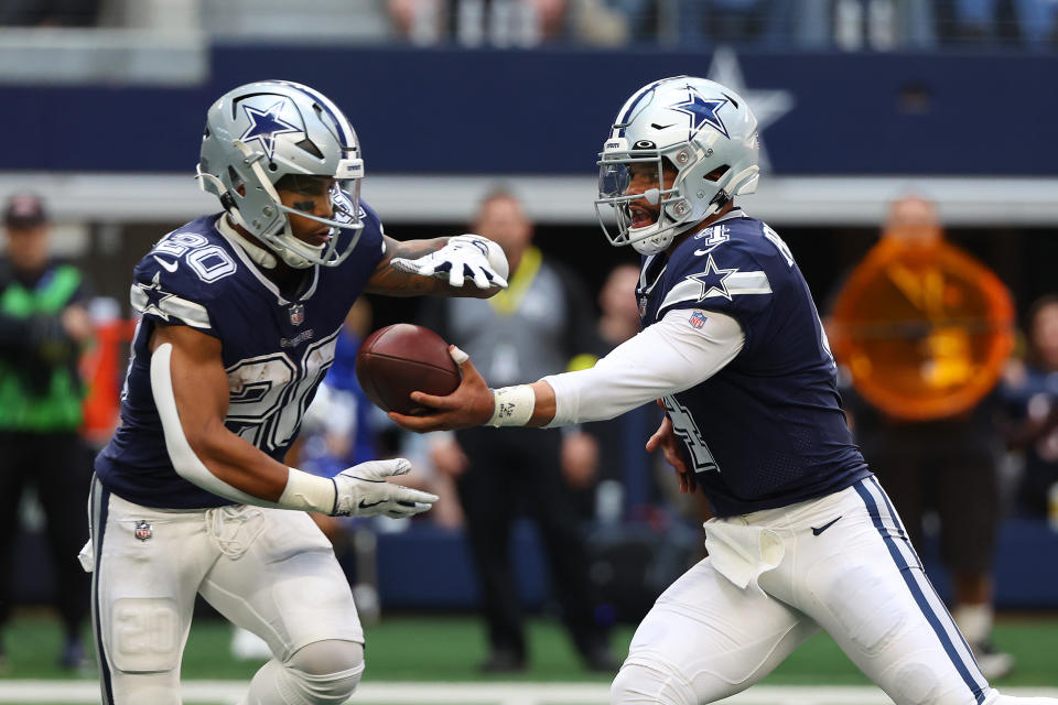 ARLINGTON, TEXAS - OCTOBER 30: Tony Pollard #20 of the Dallas Cowboys take a hand off from Dak Prescott #4 in a game against the Chicago Bears at AT&T Stadium on October 30, 2022 in Arlington, Texas. (Photo by Richard Rodriguez/Getty Images)