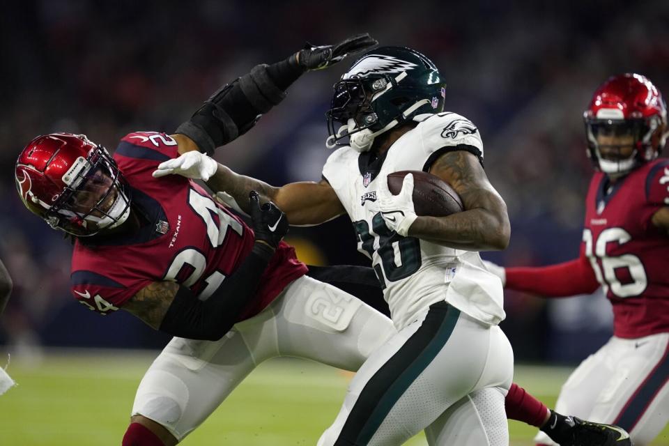 Houston Texans cornerback Derek Stingley Jr. attempts to stop Philadelphia Eagles running back Miles Sanders.