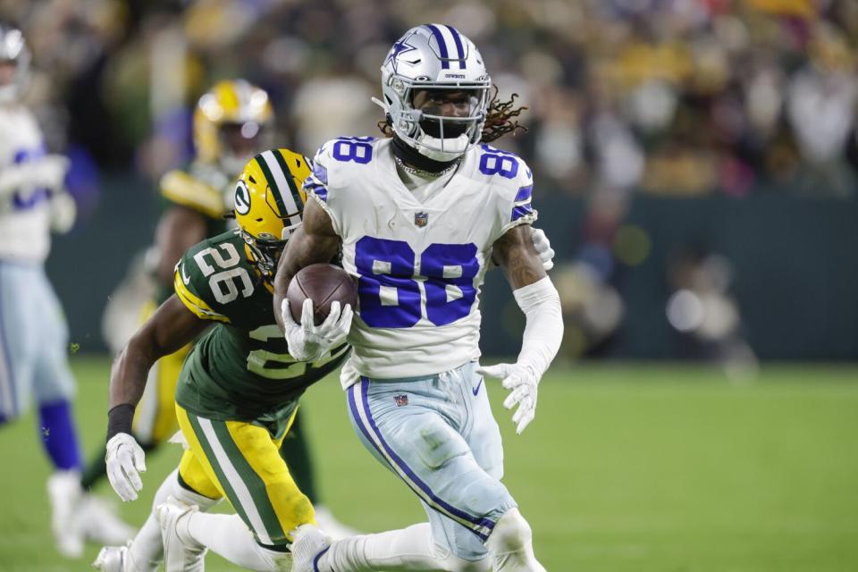 Dallas Cowboys wide receiver CeeDee Lamb breaks the tackle of Green Bay Packers safety Darnell Savage.