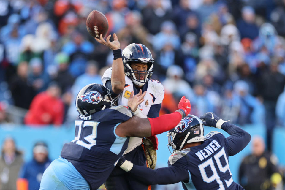 NASHVILLE, TENNESSEE - NOVEMBER 13: Teair Tart #93 of the Tennessee Titans and Rashad Weaver #99 of the Tennessee Titans hit Russell Wilson #3 of the Denver Broncos as he attempts to pass during the fourth quarter at Nissan Stadium on November 13, 2022 in Nashville, Tennessee. (Photo by Andy Lyons/Getty Images)