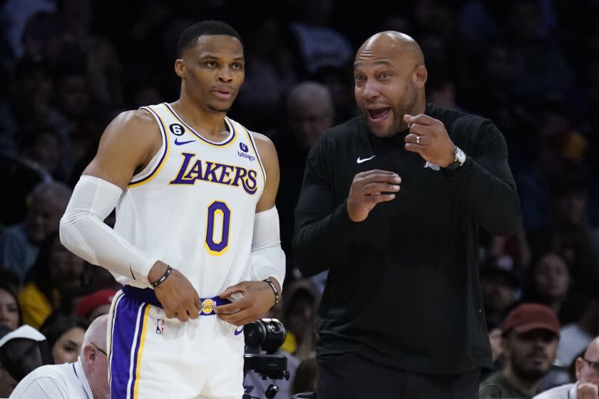 Los Angeles Lakers head coach Darvin Ham, right, talks to guard Russell Westbrook.